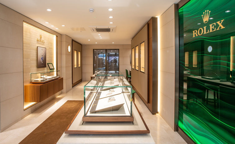 The Michael Spiers store in Plymouth. Glass display cases are seen in the middle of the store with the Rolex logo visible on the wall.
