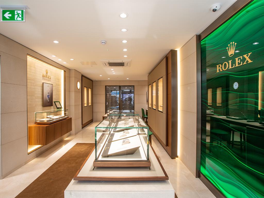The Rolex Showroom at Michael Spiers in Truro. The Rolex logo is visible on the wall on the righthand side. The entrance to the store is visible on the far side of the room.