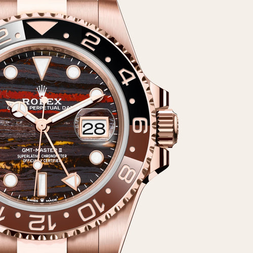 Rolex GMT-Master II in 18 ct Everose gold with a Tiger iron dial, Bidirectional rotatable 24-hour graduated bezel. Two-colour brown and black Cerachrom insert in ceramic, moulded numerals and graduations bezel, Oyster, three-piece solid links bracelet